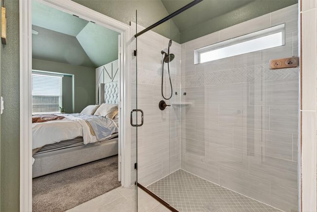 Full bath featuring ensuite bathroom, a shower stall, tile patterned floors, and lofted ceiling | Image 28