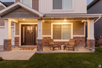 View of exterior entry with a yard and covered porch | Image 2