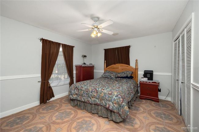 Bedroom featuring ceiling fan and a closet | Image 6