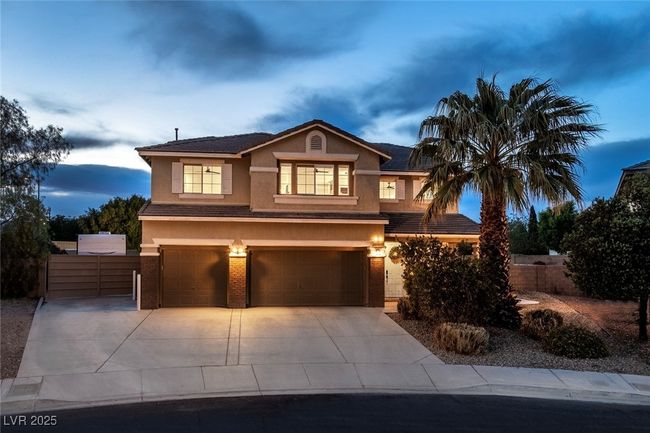 View of front of property with an attached garage, concrete driveway, stucco siding, and fence | Image 45