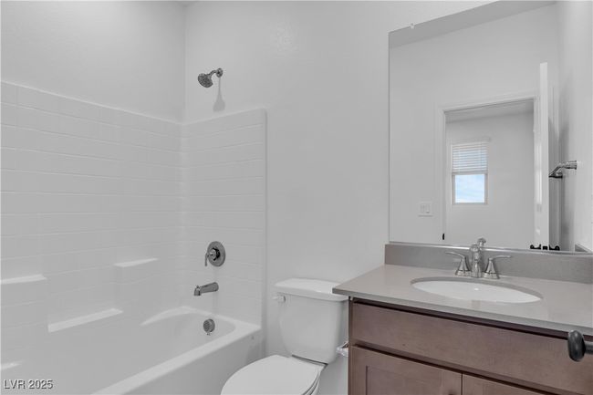 Full bathroom featuring vanity, toilet, and tub / shower combination | Image 5