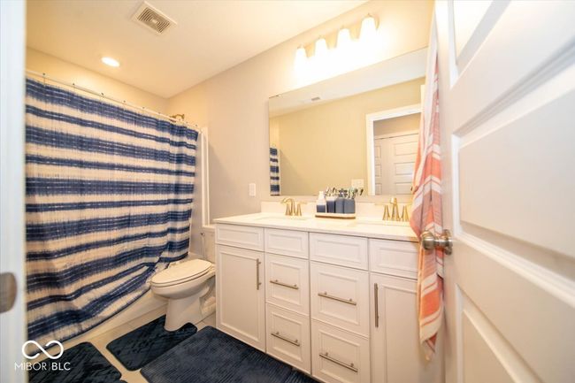 full bath with double vanity, recessed lighting, a shower with curtain, and tile patterned floors | Image 21