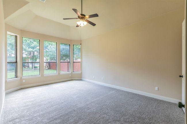 Primary bedroom with baseboards, a ceiling fan, NEW carpet flooring, and plenty of natural light | Image 17