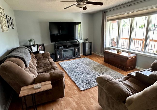 Main floor living room with large window looking out to the front porch. | Image 4