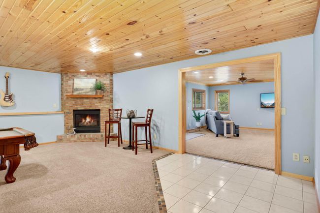 Stay warm by the LL floor-to-ceiling stone fireplace. | Image 24