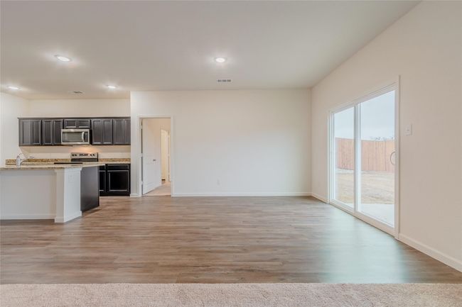 Kitchen featuring appliances with stainless steel finishes, open floor plan, light countertops, baseboards, and recessed lighting | Image 12