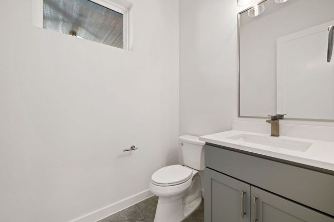 Half Bathroom featuring baseboards, vanity, and toilet | Image 16