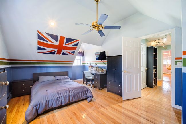 Bedroom 3 with lofted ceiling, hardwood / wood-style flooring, and baseboard heating | Image 29