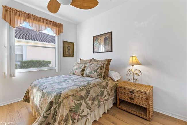 Bedroom with wood-type flooring and ceiling fan | Image 19