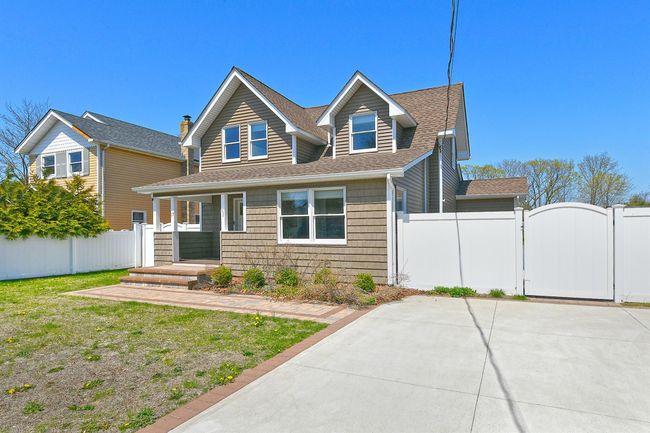 View of front of house featuring fence, a shingled roof, and a gate | Image 6