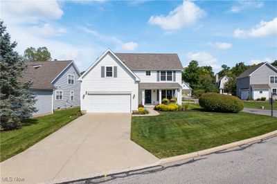 View of front of home with a garage and a front yard | Image 1