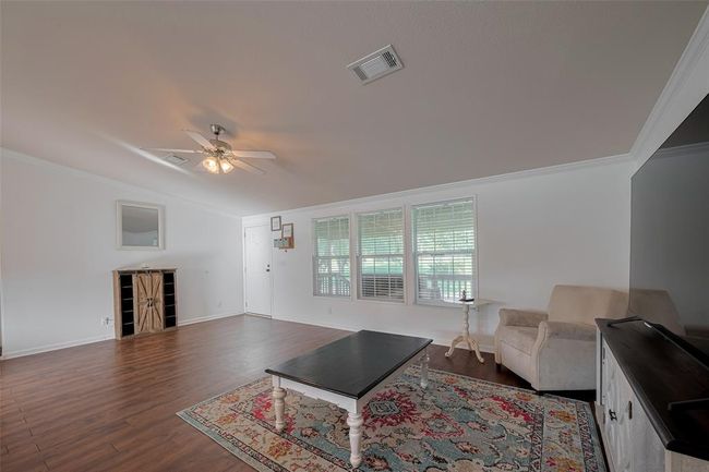 With beautiful molding and a modern ceiling fan adding a touch of sophistication. | Image 10