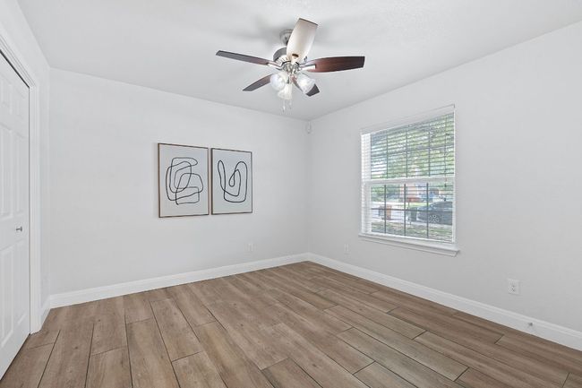 Unfurnished bedroom with wood finished floors, a closet, and a ceiling fan | Image 31