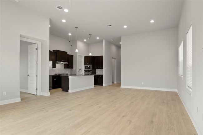 Unfurnished living room featuring light wood-style floors and recessed lighting | Image 12