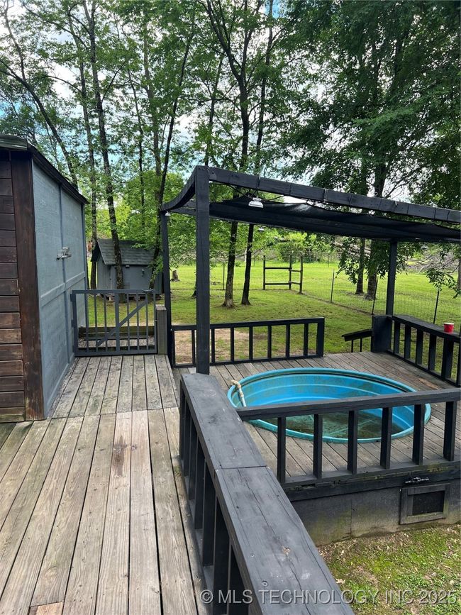 Deck featuring a lawn, a shed, and an outdoor structure | Image 32