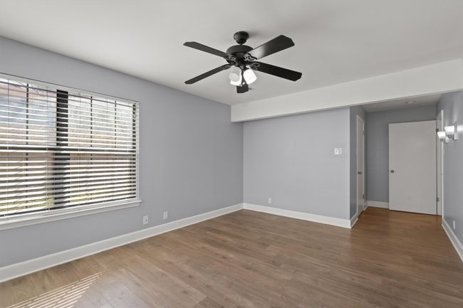 Empty room featuring a ceiling fan, wood finished floors, and baseboards | Image 25
