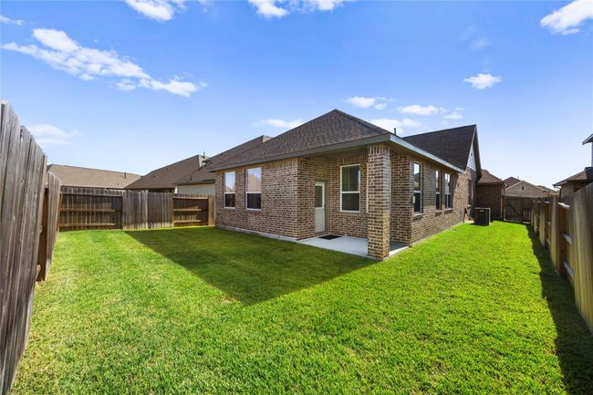 The large fenced backyard provides plenty of space for play, pets, and entertaining. It’s ready for outdoor fun or your future garden dreams. | Image 28