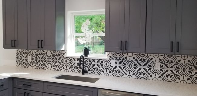 Kitchen with a sink, gray cabinetry, light countertops, and backsplash | Image 5