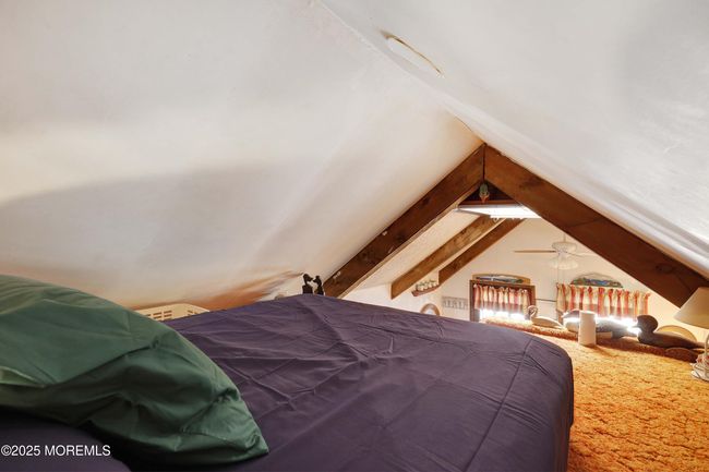 First loft overlooks the living room and is being used as a bedroom. | Image 24