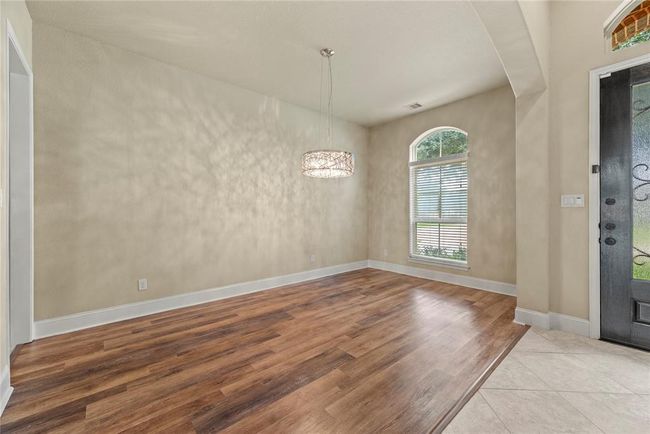 The formal dining room features durable vinyl plank flooring. | Image 7