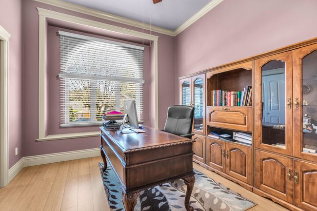 Office space with light wood finished floors, crown molding, and baseboards | Image 19