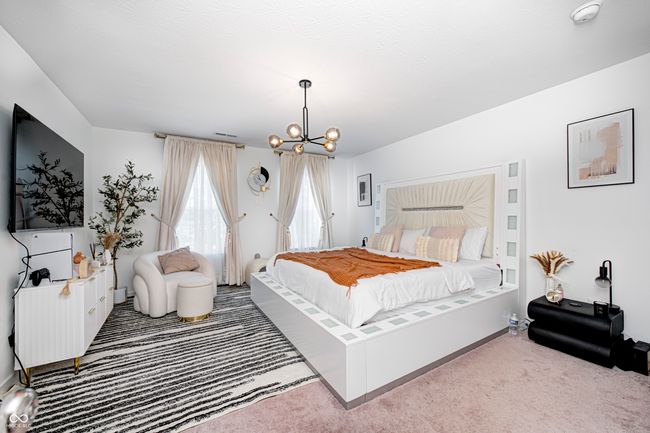 carpeted bedroom with a chandelier and baseboards | Image 24