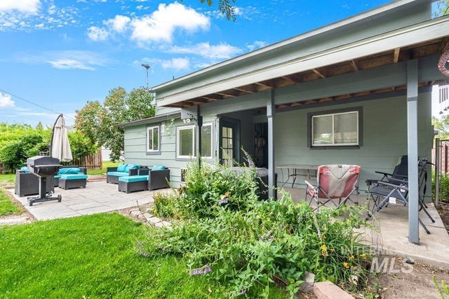 Rear view of house with outdoor lounge area and a patio area | Image 5