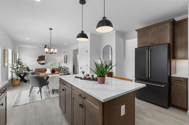 Kitchen with decorative light fixtures, light hardwood / wood-style floors, and high end fridge | Image 11