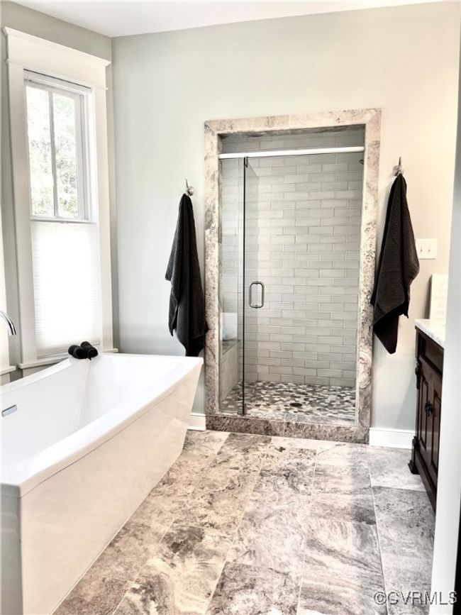Full bath featuring a bath, a stall shower, and vanity | Image 31