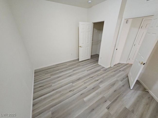 Unfurnished bedroom with light wood finished floors and baseboards | Image 28