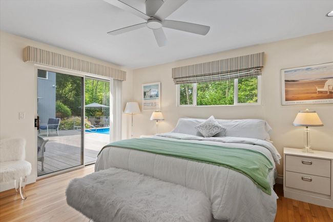 Bedroom with access to exterior, wood finished floors, and ceiling fan | Image 13