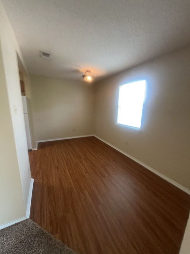 Spare room with baseboards and wood finished floors | Image 7