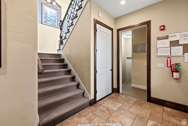 Staircase with stone tile floors and baseboards | Image 29