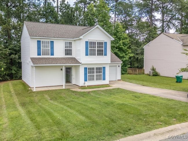 View of front of home featuring roof with shingles, concrete driveway, and a front lawn | Image 4