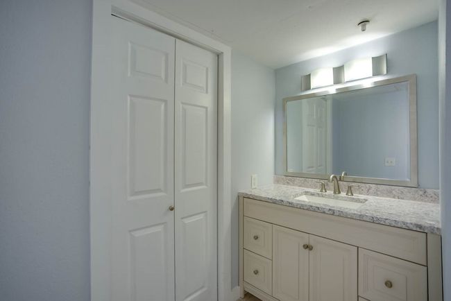 Bathroom with vanity and a closet | Image 12