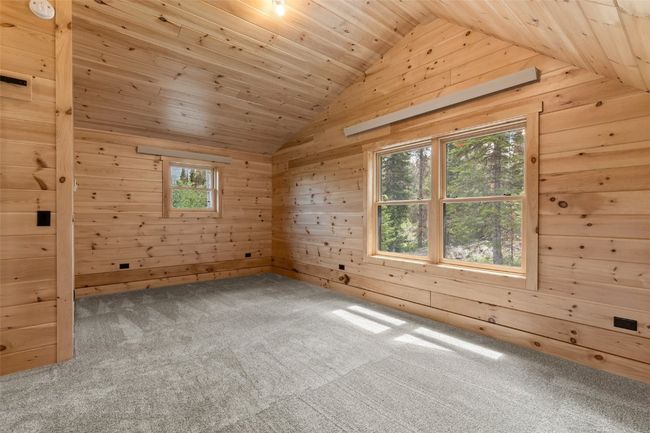 Upstairs bedroom or flex space upstairs with t&g ceiling, plenty of natural light, carpeted floors, and vaulted ceiling | Image 28