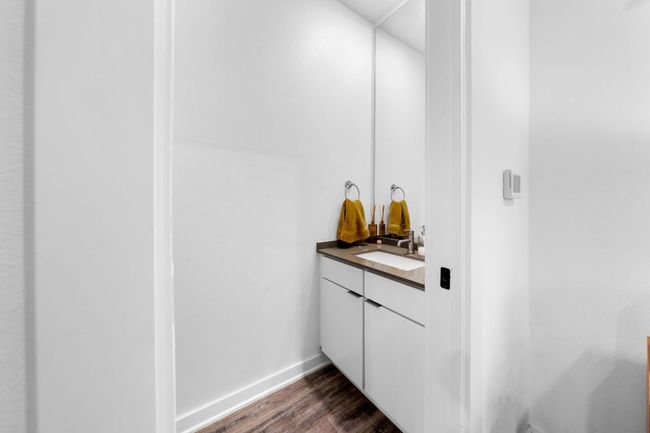 Bathroom with baseboards, wood finished floors, and vanity | Image 16