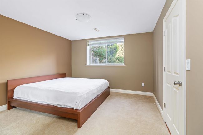 Bedroom featuring baseboards and light carpet | Image 6
