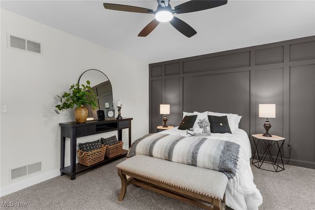 Bedroom with light carpet, a decorative wall, and a ceiling fan | Image 21