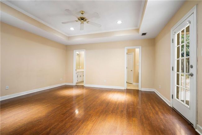 Spare room featuring a tray ceiling, hardwood / wood-style floors, ceiling fan, ornamental molding, and recessed lighting | Image 16