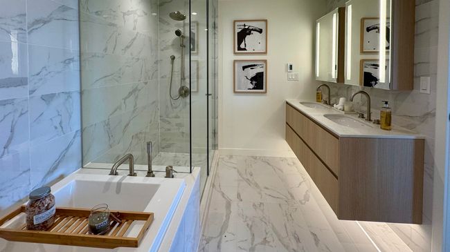 Bathroom with a garden tub, marble finish floor, baseboards, and a sink | Image 8