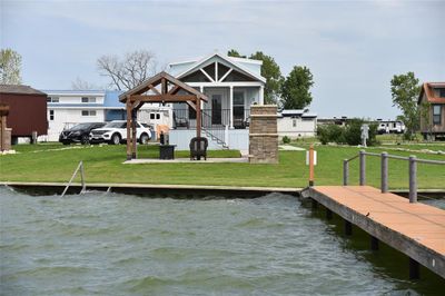 View of dock with a lawn and a water view | Image 1