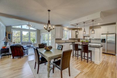 Step inside to a thoughtfully designed, spacious open layout filled with natural light and adorned with refinished original hardwood floors. | Image 2