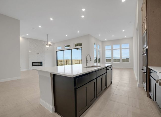 Kitchen featuring recessed lighting, light countertops, and a sink | Image 9