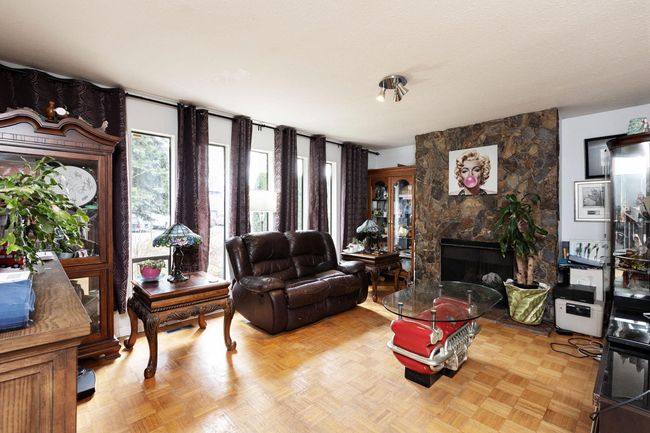Living room featuring a stone fireplace | Image 7