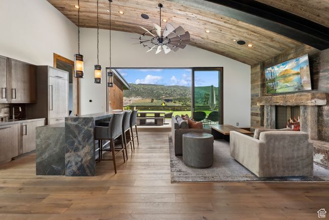 Living room featuring high vaulted ceiling, recessed lighting, light wood finished floors, and wood ceiling with exposed beams | Image 113