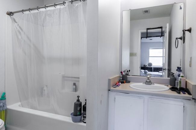 Bathroom with vanity, shower / tub combo with curtain, and ensuite bath | Image 25
