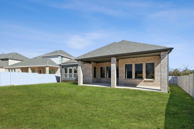 Back of house featuring brick siding, a patio, a shingled roof, and a fenced backyard | Image 30