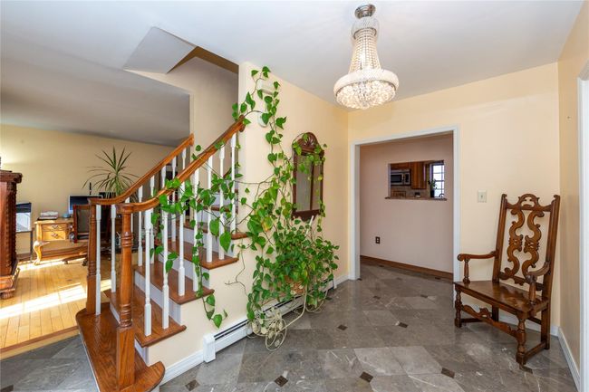 Stairs with a chandelier and baseboards | Image 15