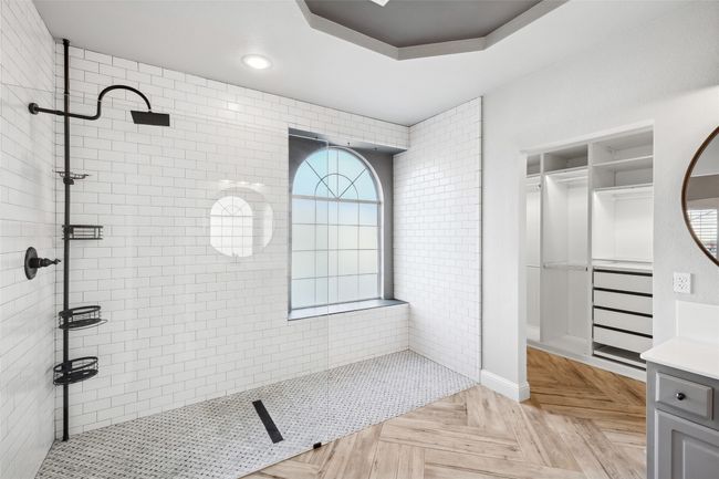 Bathroom with vanity, a raised ceiling, parquet floors, and a tile shower | Image 20